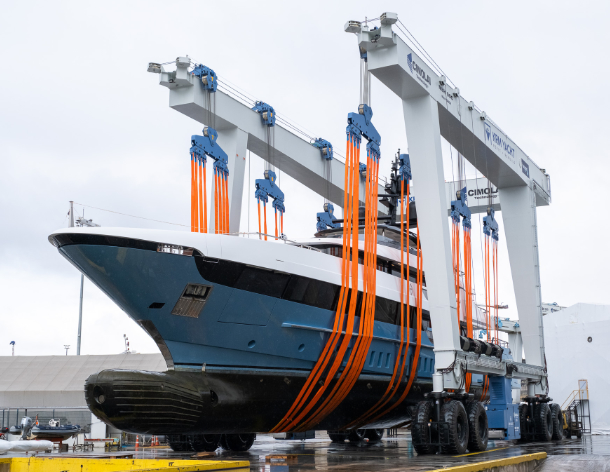Luxury yacht being lifted with a travel lift at KRM Yacht shipyard during refit operation