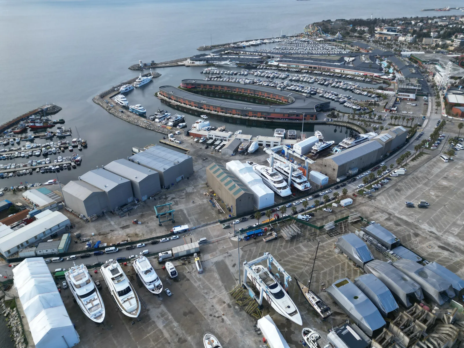 AERIAL VIEW OF THE KRM YACHT REFIT YARD IN TUZLA, ISTANBUL, WITH YACHTS ON THE HARD-STANDING AND COVERED SHEDS